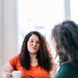 Two women are talking together